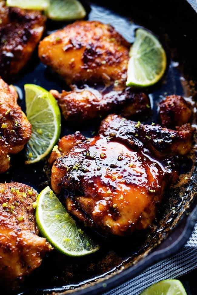 Delicious spiced rubbed chicken cooked to tender and juicy perfection. It gets glazed with the most amazing honey lime sauce and is sure to be a huge hit! Skillet honey lime chicken in a large black skillet.