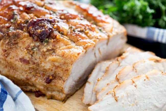 Honey Chipotle Pork Roast offers sweet heat along with ease and comfort. Sliced Honey Chipotle Pork Roast on a wooden cutting board.