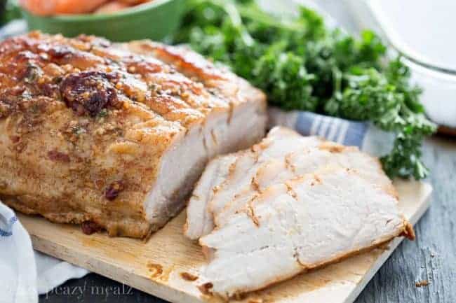 Honey Chipotle Pork Roast offers sweet heat along with ease and comfort. Sliced Honey Chipotle Pork Roast on a wooden cutting board.