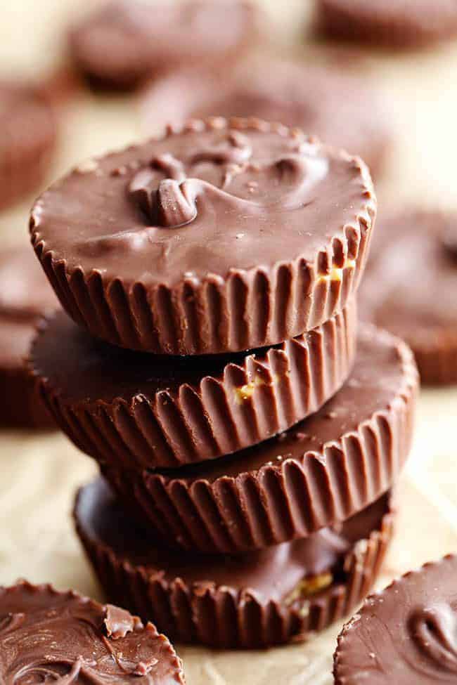 Homemade Reese's Peanut Butter Cupsย come together in just 15 minutes and are even better than the real thing! Homemade Reeses peanut butter cups stacked on top of one another.