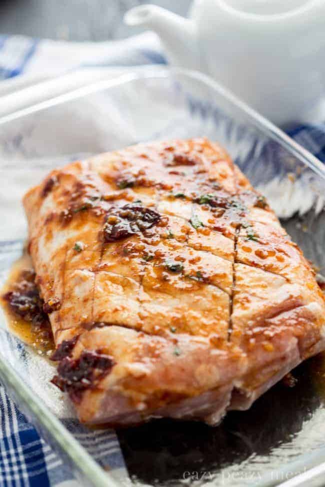 Honey Chipotle Pork Roast offers sweet heat along with ease and comfort. Uncooked Honey Chipotle Pork Roast in a clear pan.