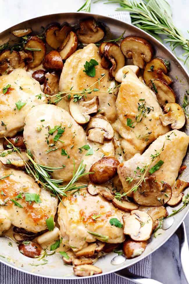 Creamy Garlic Herb Mushroom Chicken is a quick and easy 30 minute meal with amazing restaurant quality taste! The creamy garlic and fresh herb mushroom sauce over this chicken is insanely delicious! Creamy Garlic Herb Mushroom Chicken in a metal frying pan.
