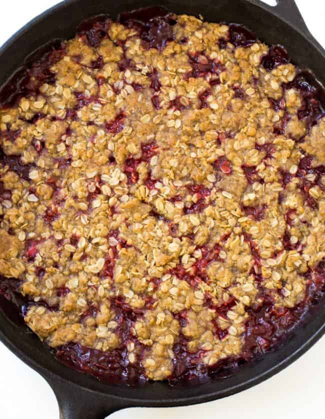 Super Easy Strawberry Crisp. The perfect dessert for summer! Strawberry Crisp in a large black skillet.
