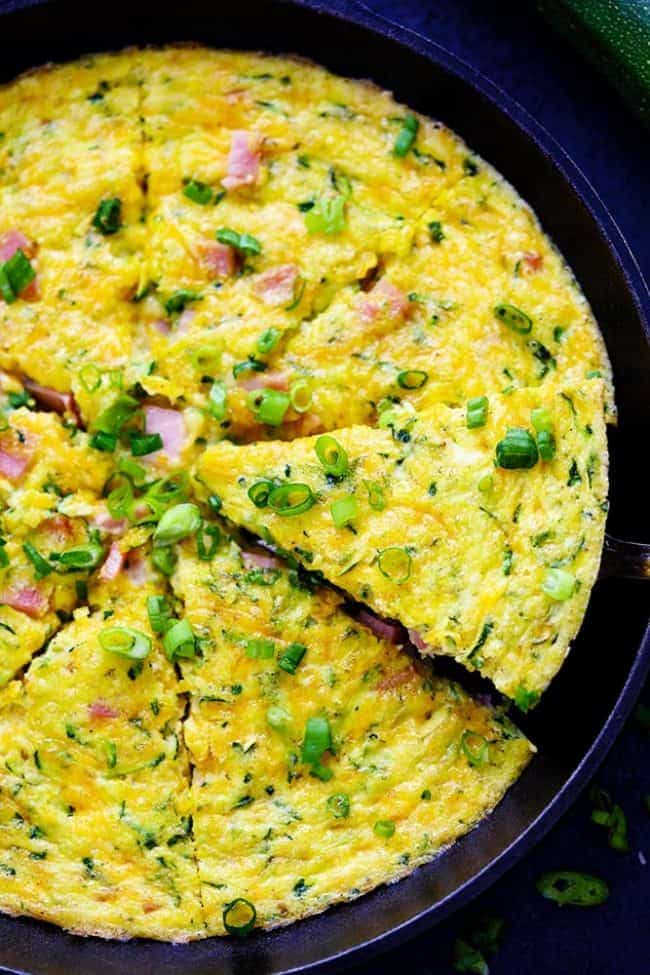 Ham and Cheddar Zucchini Frittata is filled with two cups of zucchini, ham, and cheddar cheese. It has such amazing flavor and will be devoured in no time at all! Ham and Cheddar Zucchini Frittata in a large pan.