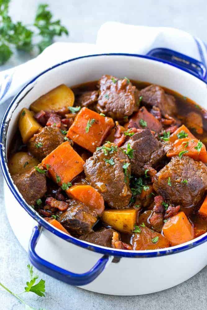 Beef Stew with Baconย is full of tender meat, colorful veggies and plenty of smoky bacon. A one pot meal that's perfect for cold weather! Beef stew with bacon in a large pot.