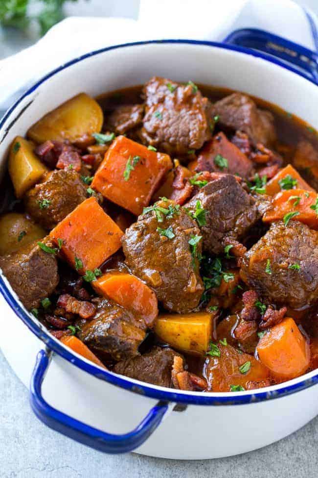 Beef Stew with Baconย is full of tender meat, colorful veggies and plenty of smoky bacon. A one pot meal that's perfect for cold weather! Beef stew with bacon and a large pot.