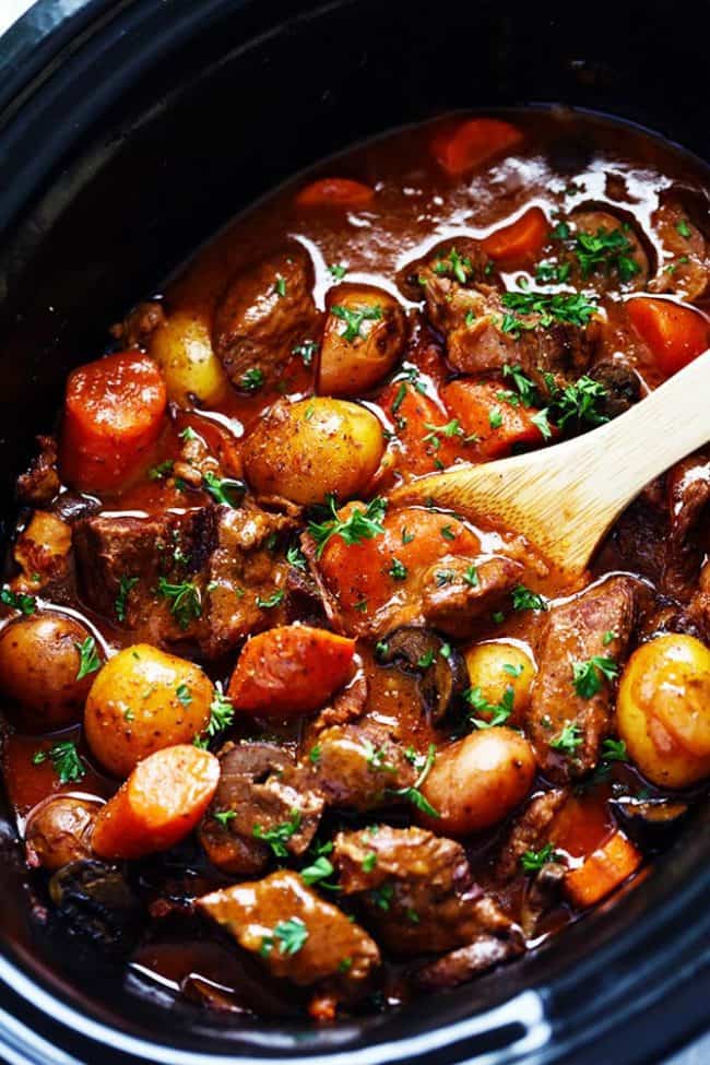 Slow Cooker Beef Bourguignon has crazy tender melt in your mouth beef and hearty veggies slow cooked to perfection in a rich sauce. ย This meal is comforting and perfect for the cold months ahead! Slow Cooker Beef Bourguignon