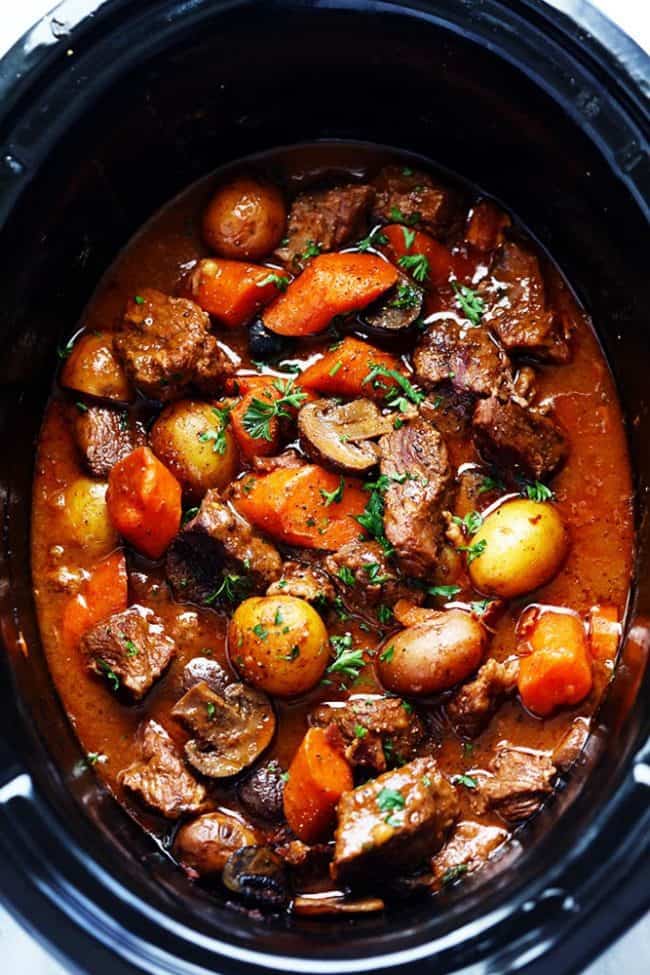 Slow Cooker Beef Bourguignon has crazy tender melt in your mouth beef and hearty veggies slow cooked to perfection in a rich sauce. ย This meal is comforting and perfect for the cold months ahead! Slow Cooker Beef Bourguignon