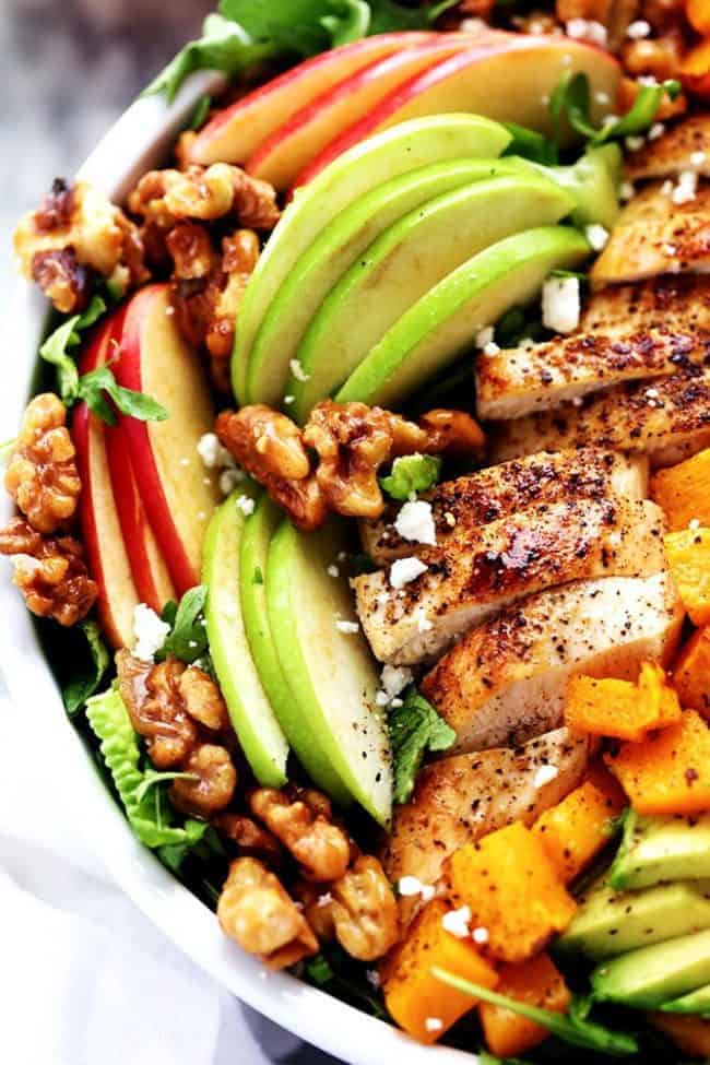 Harvest Cobb Chicken Salad with a Honey Apple Cider Vinaigrette is filled with crisp fall apples, roasted butternut squash, and all of the delicious things of fall come together in this mouthwatering salad. Up close photo of harvest cup chicken salad in a white bowl.