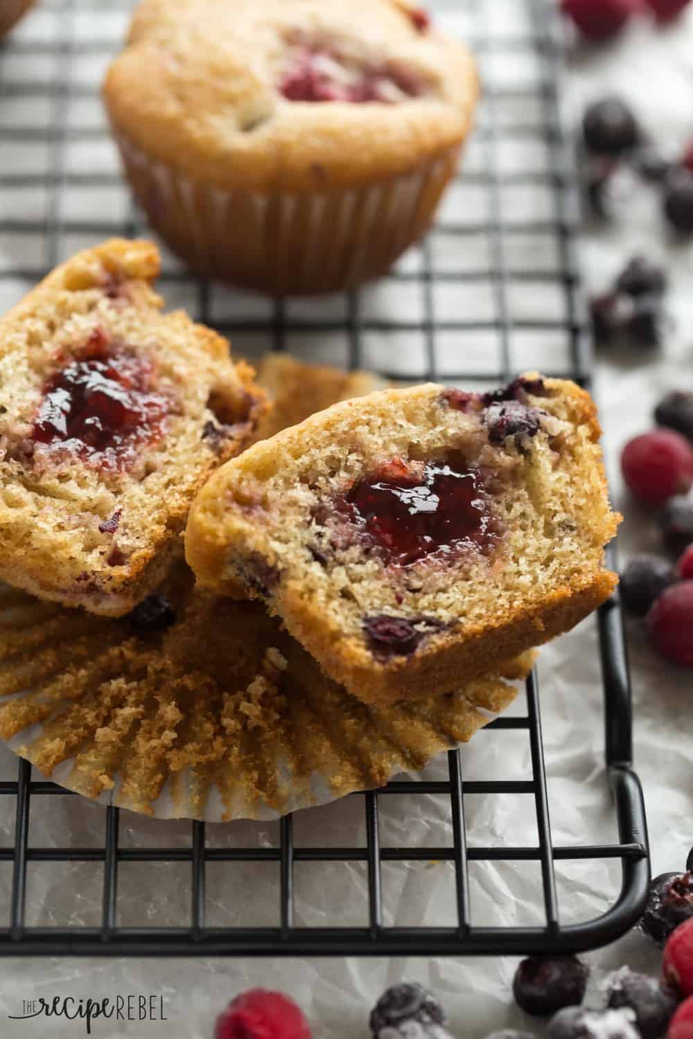 These Fruit Explosion Muffins are packed with berries and have a strawberry surprise in the center! They are just as good as your bakery favorite but madeย completely from scratch. These Fruit Explosion Muffins cut in half to revel inside.