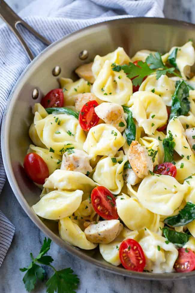 This Oneย Pot Creamy Parmesan Chicken Tortellini is aย family friendly meal that's ready in no time! It's packed full of golden brown chicken, veggies and tortellini, all in a creamy parmesan sauce. This one pot chicken with tortellini in a pot.