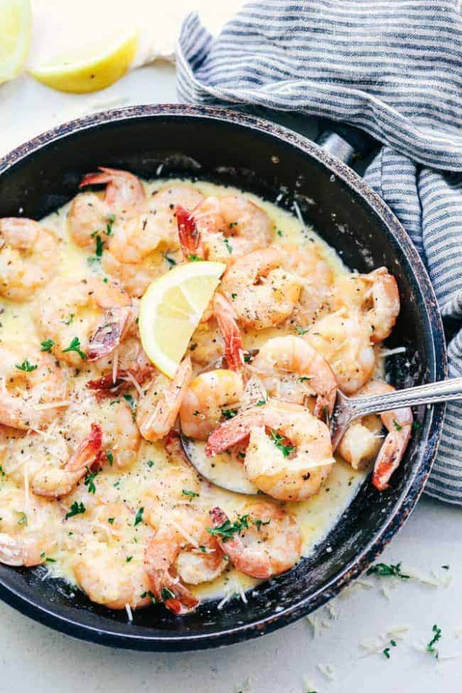 Creamy Parmesan Garlic Shrimp Pasta is the perfect quick and easy meal that is on the dinner table in less than 20 minutes! Shrimp get coated in the very best creamy parmesan garlic sauce and is wonderful tossed with fresh pasta. Creamy Parmesan Garlic Shrimp Pasta in a saute pan.