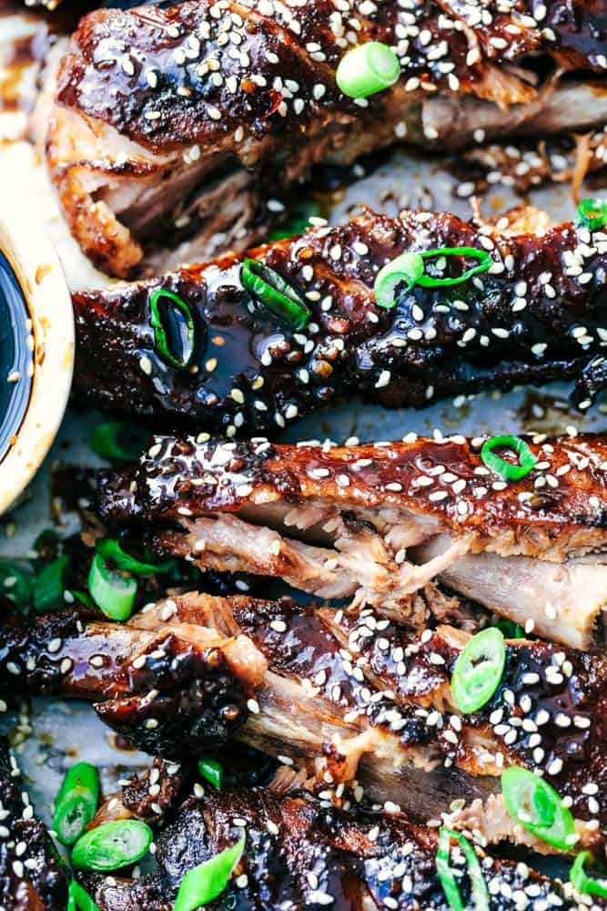 Slow Cooker Sticky Asian Ribs with Sticky Sauce are the very best fall of the bone tender ribs you will ever make! Slow cooked to perfection in a sweet and tangy asian sauce. They get slathered right before serving in a finger licking good sticky sauce! Slow Cooker Sticky Asian Ribs with Sticky Sauce