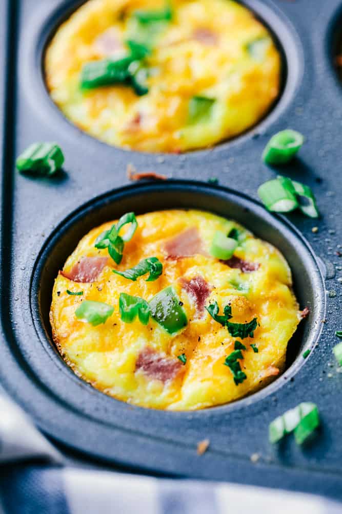 Denver Omelet Breakfast Muffins are such a great breakfast and perfect for making ahead or on the go! Loaded with Peppers, onions, ham and ooey gooey cheese, these will become a favorite! Denver Omelet Breakfast Muffin in a muffin pan.