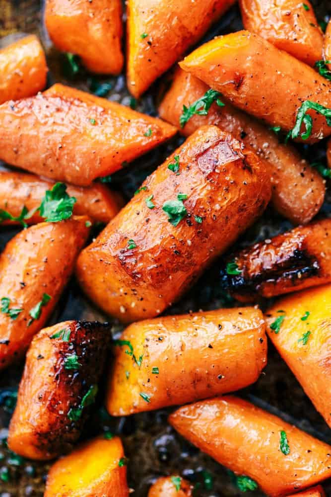Roasted brown butter honey garlic carrots make an excellent side dish. Roasted to tender perfection in the most incredible sauce these will instantly become a new favorite! Closeup of roasted brown butter honey garlic carrots.