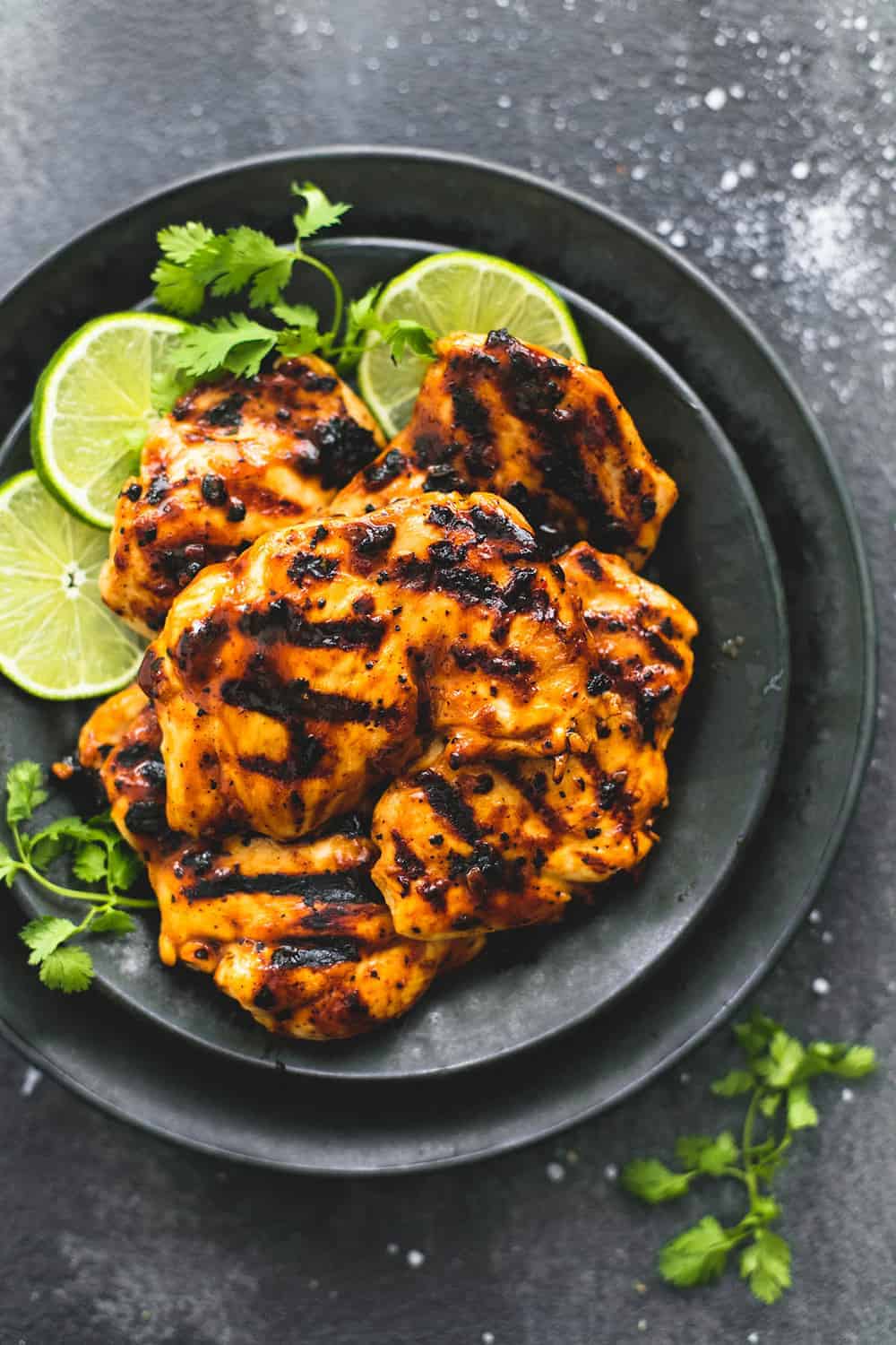 Grilled Chili Lime Chicken is made with tender and juicy grilled chicken with the best chili lime marinade! This is one that your family will love! Grilled Chili Lime Chicken on a black plate.