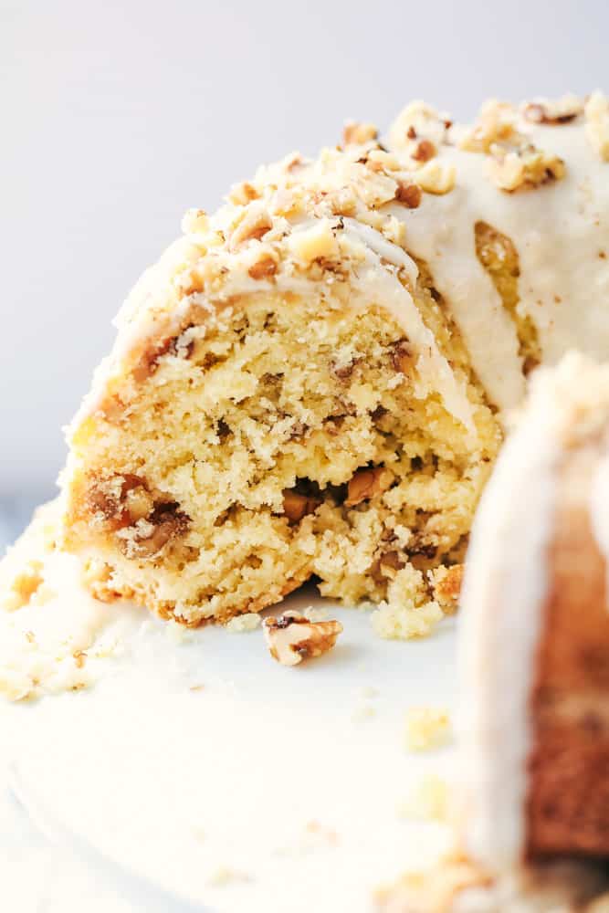 Glazed Walnut Butter Cake is a perfectly moist and tender buttery cake filled with walnuts and made with ingredients you already have on hand. This cake gets a delicious glaze and is topped with chopped walnuts and will become a new favorite! View of the inside of Glazed Walnut Butter Cake