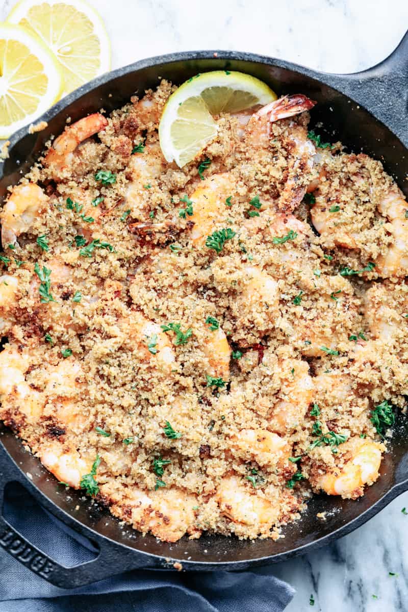 Crunchy Baked Parmesan Garlic Shrimp is buttery and delicious parmesan garlic shrimp coated and baked to crispy crunchy perfection. The flavor is incredible and you won't be able to get enough! Crunchy Baked Parmesan Garlic Shrimp in a cast iron skillet.