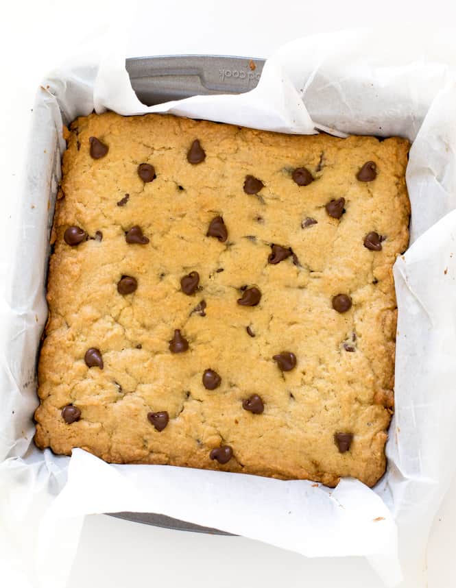 Amazing Brookie Bars! A layer of chewy chocolate chip cookie and a layer of fudgey brownie. The best of both worlds! Areal view of brookie bars in a pan.