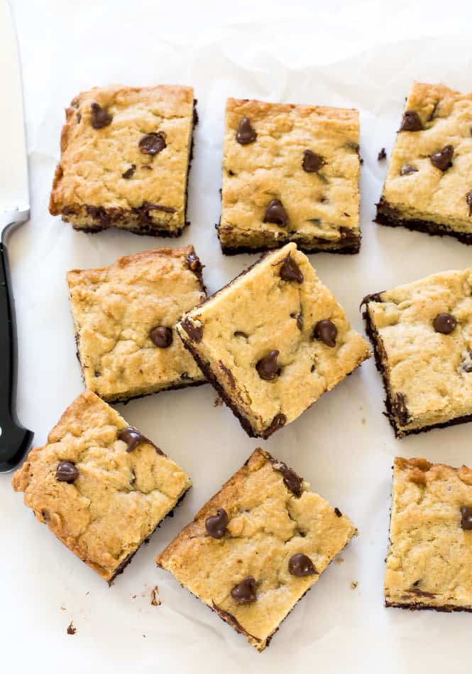 Amazing Brookie Bars! A layer of chewy chocolate chip cookie and a layer of fudgey brownie. The best of both worlds! Amazing Brookie Bars in rows.