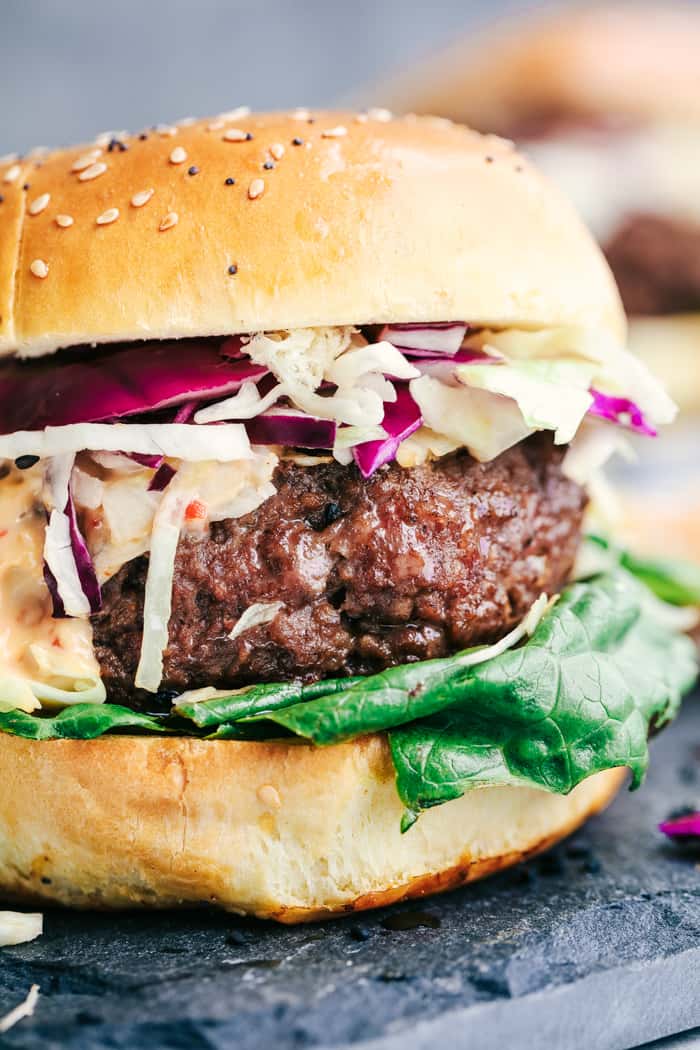 Asian Barbecue Burgers with Sweet Chili Lime Mayo are crazy and tender juicy burgers infused with asian spices. Topped with an asian slaw and a sweet chili lime mayo you will never go back to boring burgers again!ย Asian Barbecue Burgers with Sweet Chili Lime Mayo