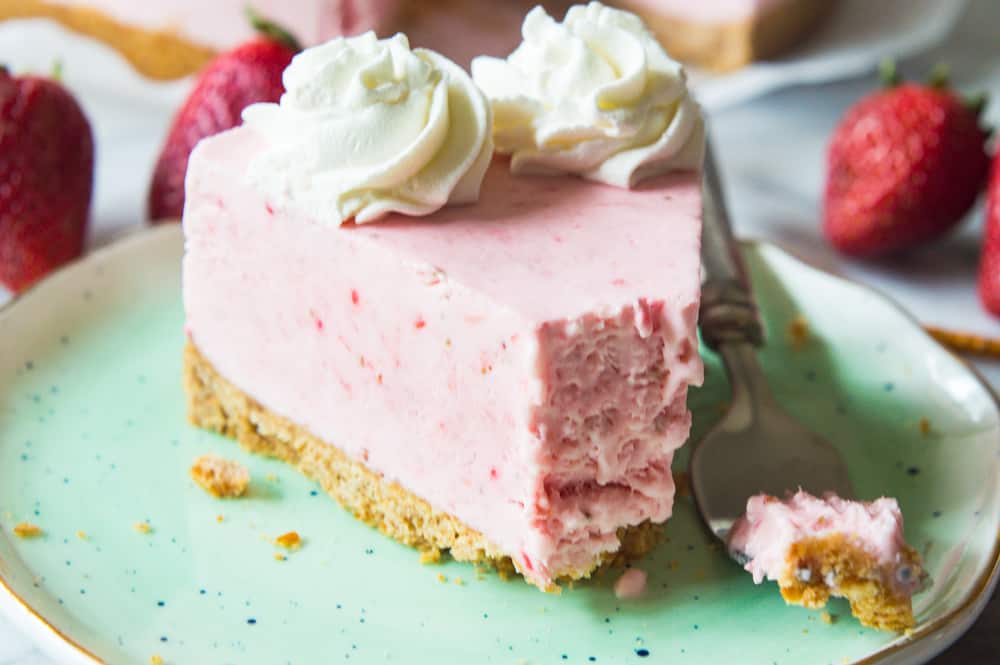 No Bake Frozen Strawberry Yogurt Pie! This frozen pie is perfect for warmer weather! No baking needed, and the pie itself is a creamy cool strawberry and cream flavor. Made with greek yogurt, real cream, and fresh strawberry puree! All on top of a pretzel crust. No Bake Frozen Strawberry Yogurt Pie! This frozen pie is perfect for warmer weather! No baking needed, and the pie itself is a creamy cool strawberry and cream flavor. Made with greek yogurt, real cream, and fresh strawberry puree! All on top of a pretzel crust.