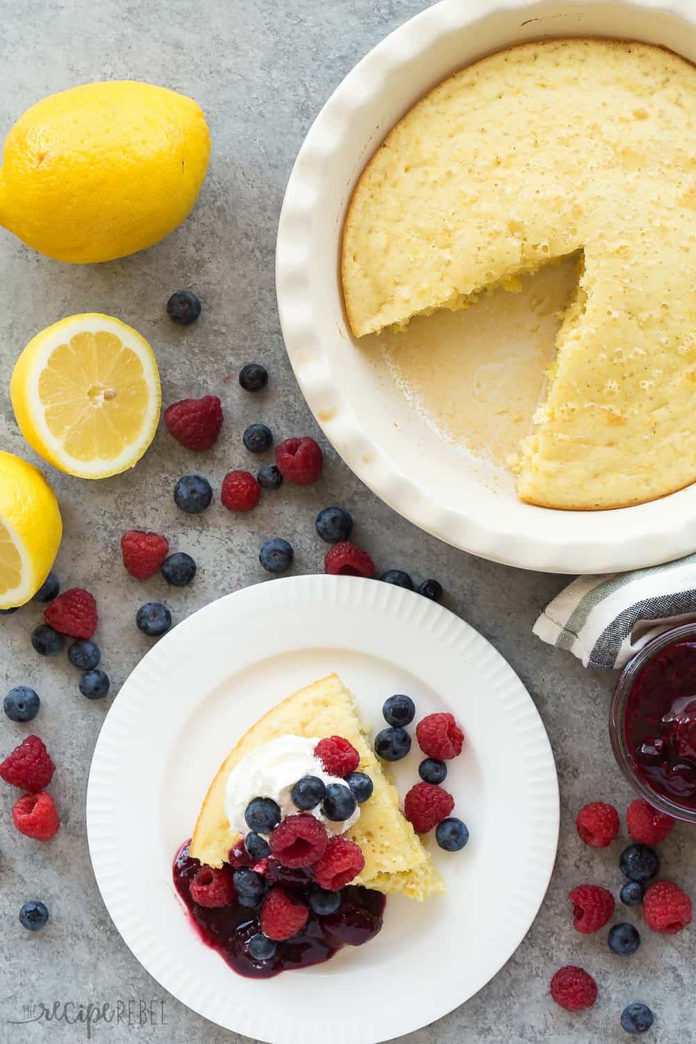 This Lemon Baked Pancake with Berry Sauce is such an easy breakfast for serving a crowd! Perfect for all your holiday brunches. This Lemon Baked Pancake with Berry Sauce slice on a white plate.