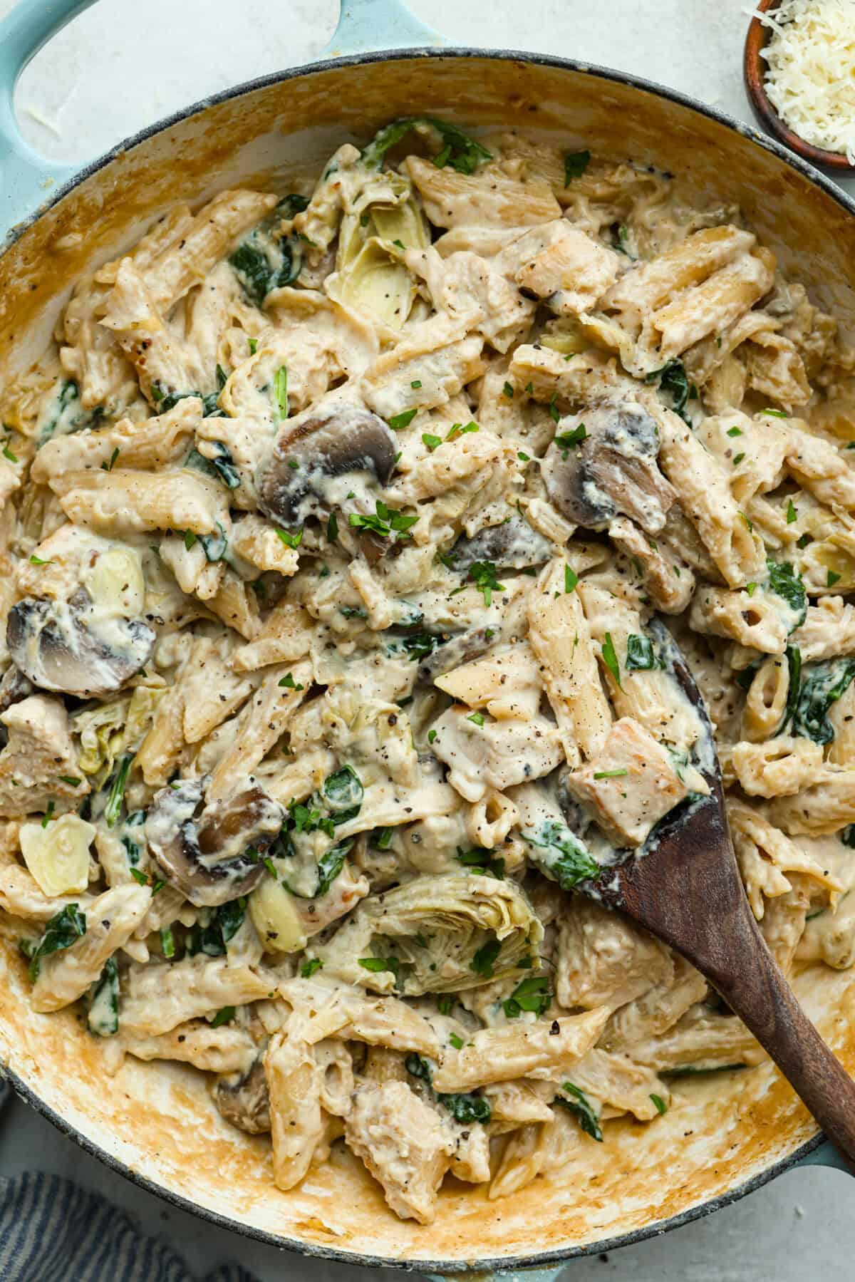 Creamy Spinach Mushroom Artichoke Chicken comes together in just 30 minutes with only one pot! It's a rich, flavorful meal I know you guys will love! Overhead shot of creamy spinach mushroom artichoke chicken in a skillet.