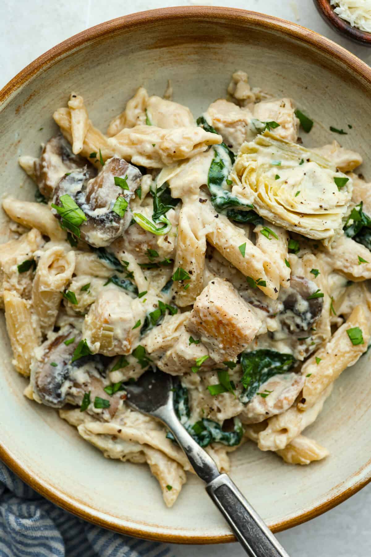 Creamy Spinach Mushroom Artichoke Chicken comes together in just 30 minutes with only one pot! It's a rich, flavorful meal I know you guys will love! Plated creamy spinach mushroom artichoke chicken.