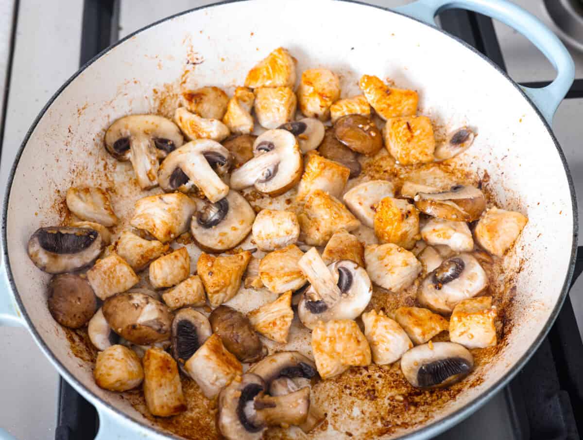 Creamy Spinach Mushroom Artichoke Chicken comes together in just 30 minutes with only one pot! It's a rich, flavorful meal I know you guys will love! Mushrooms, garlic and olive oil cooking in a skillet.