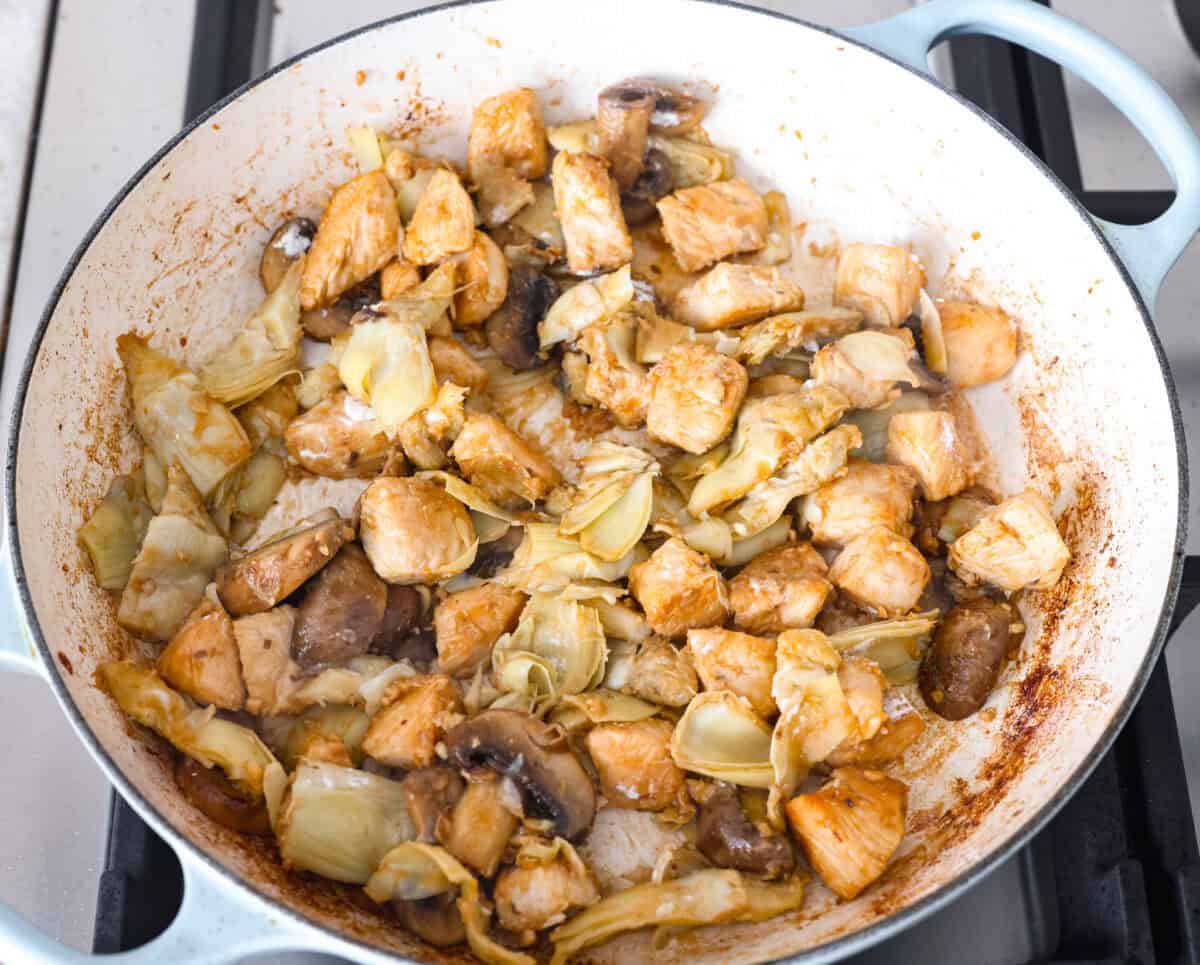 Creamy Spinach Mushroom Artichoke Chicken comes together in just 30 minutes with only one pot! It's a rich, flavorful meal I know you guys will love! Artichokes and flour added to the mushrooms and chicken.