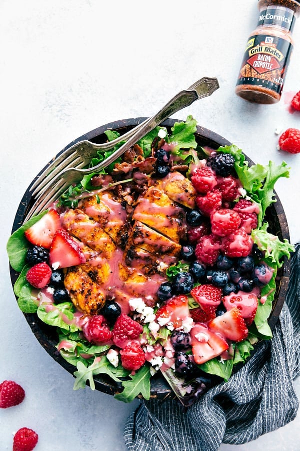 Grilled Berry Feta Chicken Salad is loaded with fresh summer berries, bacon chipotle seasoned grilled chicken and topped with a sweet chipotle dressing! You will be craving this mouthwatering salad all summer long!ย Grilled Berry Feta Chicken Salad in a bowl.
