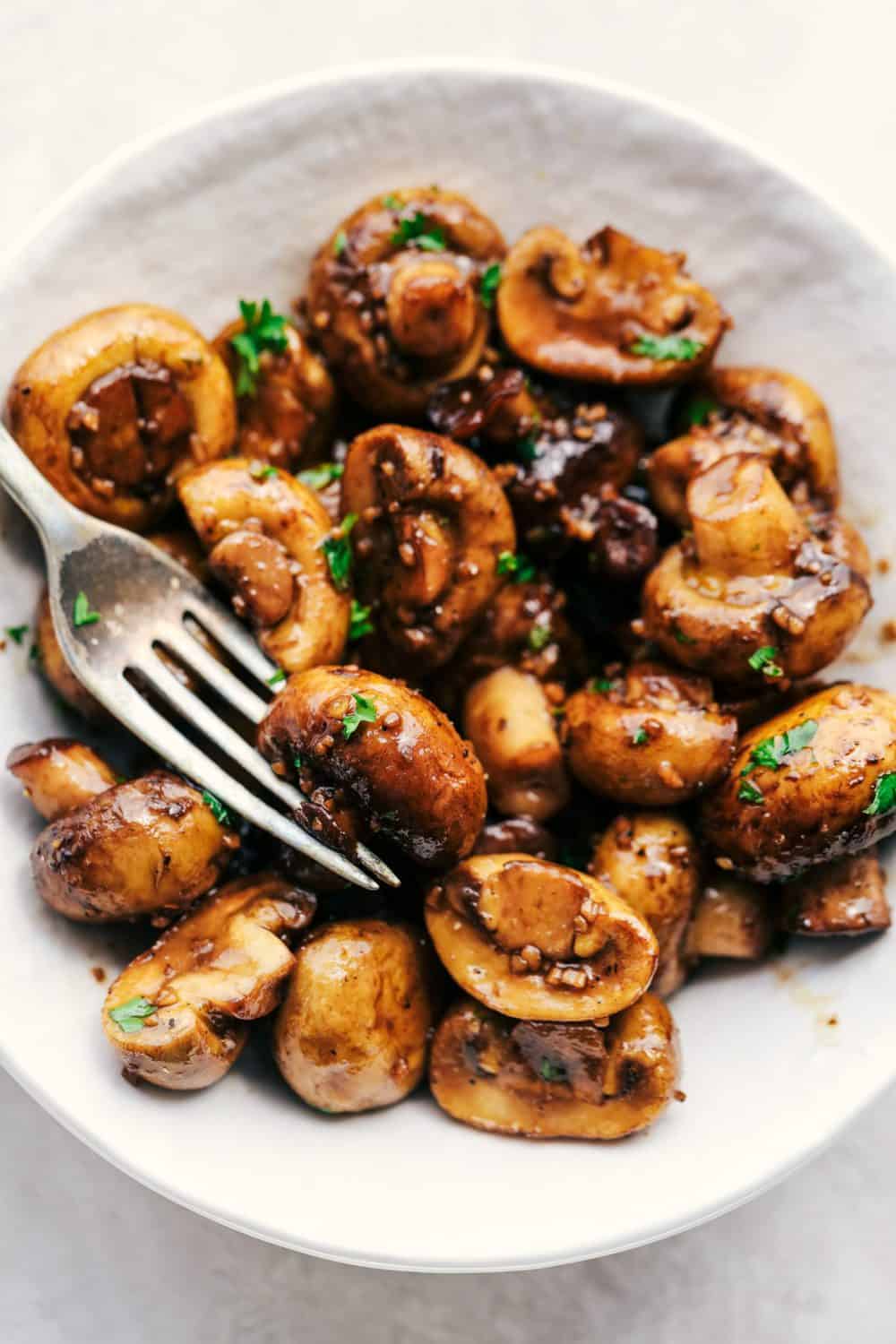 Honey Balsamic Garlic Mushrooms are sautรฉed in the most incredible honey balsamic garlic sauce. This makes an excellent topping for steak or chicken or is even great as a side dish!ย Honey Balsamic Garlic Mushrooms