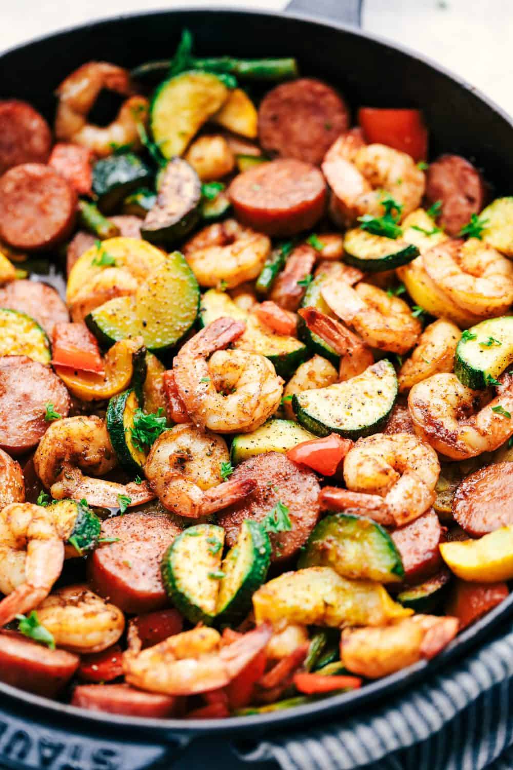Cajun Shrimp and Sausage Vegetable Skillet is the BEST 20 minute meal packed with awesome cajun flavor with shrimp, sausage, and summer veggies. This makes a great low carb meal and is also great for meal prep! Cajun Shrimp and Sausage Vegetables in a Skillet