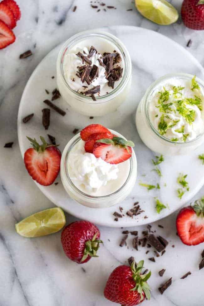 Coconut Mousse. This fluffy coconut mousse comes together quick and easy and is loaded with a cold, creamy coconut flavor! Top with your favorite toppings and it's the perfect summer dessert! Coconut Mousse in glass jars on a white plate.
