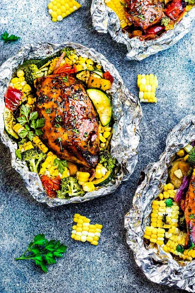 Grilled Honey Barbecue Chicken Foil Packets are the easiest summer meal with practically no clean-up! Perfectly tender chicken grilled with fresh summer veggies and coated in a delicious sweet and tangy barbecue sauce. Grilled Honey Barbecue Chicken Foil Packets