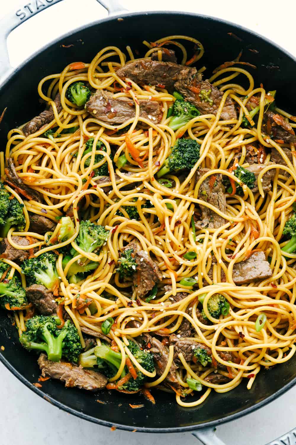 Beef and Broccoli Lo Mein has melt in your mouth tender beef with broccoli, carrots, and noodles. The sauce adds such amazing flavor to this incredibly easy meal! Beef and broccoli lo mein in a skillet.