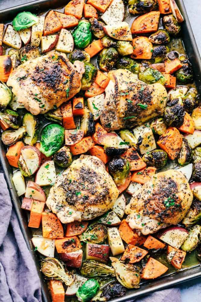 Sheet Pan Roasted Garlic Butter Herb Chicken is such a rustic and incredible dish. Surrounded by sweet potatoes and brussels sprouts this meal is loaded with amazing garlic butter herb flavor! Sheet Pan Roasted Garlic Butter Herb Chicken with Potatoes and Brussels Sprouts