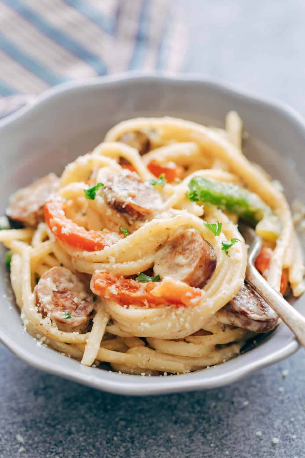 Creamy Cajun Sausage Linguine is a creamy 30 minute pasta recipe that's going to become a family favourite! Not too heavy on the cheese but still super creamy! Creamy Cajun Sausage Linguine in a bowl.