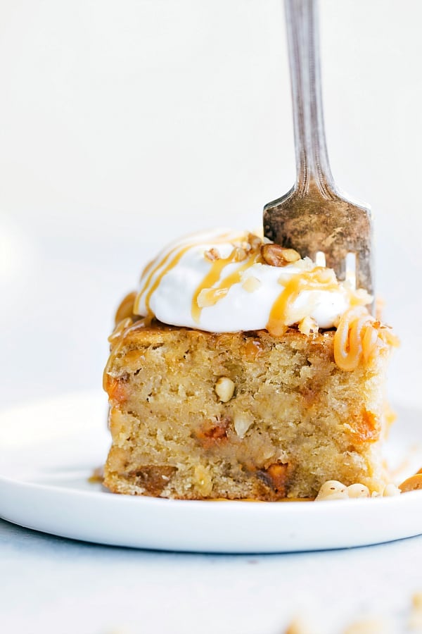 Sticky Banana Walnut Toffee Pudding Cake is a perfectly baked banana walnut pudding cake topped with the most amazing toffee caramel sauce. This will be one of the best desserts you will ever have!ย Sticky Banana Walnut Toffee Pudding Cake on a white plate.