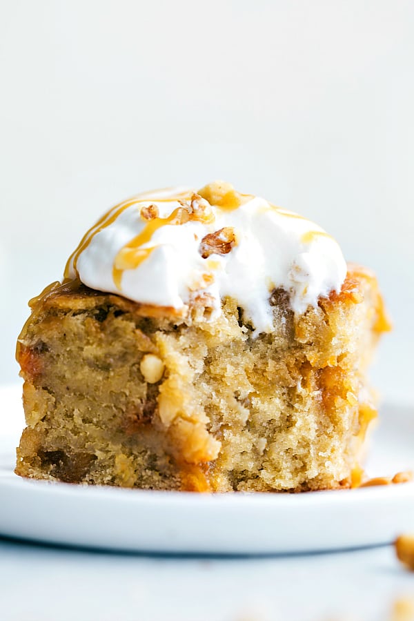 Sticky Banana Walnut Toffee Pudding Cake is a perfectly baked banana walnut pudding cake topped with the most amazing toffee caramel sauce. This will be one of the best desserts you will ever have!ย Sticky Banana Walnut Toffee Pudding Cake on a white plate.