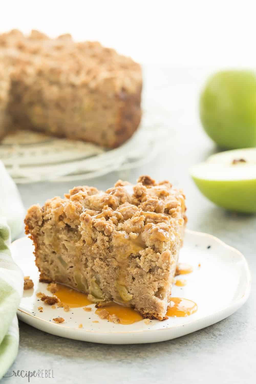 This Crumb-Topped Apple Coffee Cake is perfect for fall! Greek yogurt and extra apples keep it moist and a crunchy crumb topping gives it extra decadence! A slice of Crumb-Topped Apple Coffee Cake.