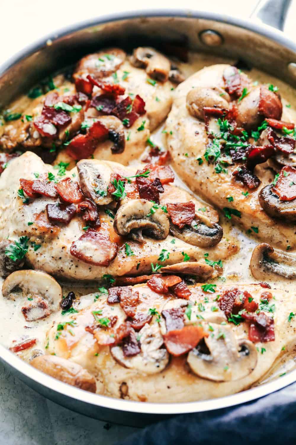 Creamy Balsamic Mushroom Bacon Chicken has the most amazing creamy balsamic mushroom sauce with tender and juicy chicken topped with crispy bacon. This is an easy restaurant quality meal you can make at home! Creamy Balsamic Mushroom Bacon Chicken in a skillet.