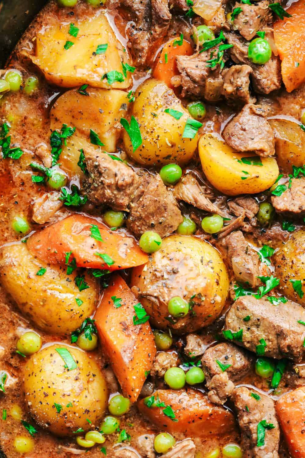 Best Ever Slow Cooker Beef Stew is the absolute perfect comforting beef stew. A thick and rich sauce filled with hearty and chunky potatoes, carrots, onions, and peas with the most amazing tender melt in your mouth beef! Best Ever Slow Cooker Beef Stew close up.