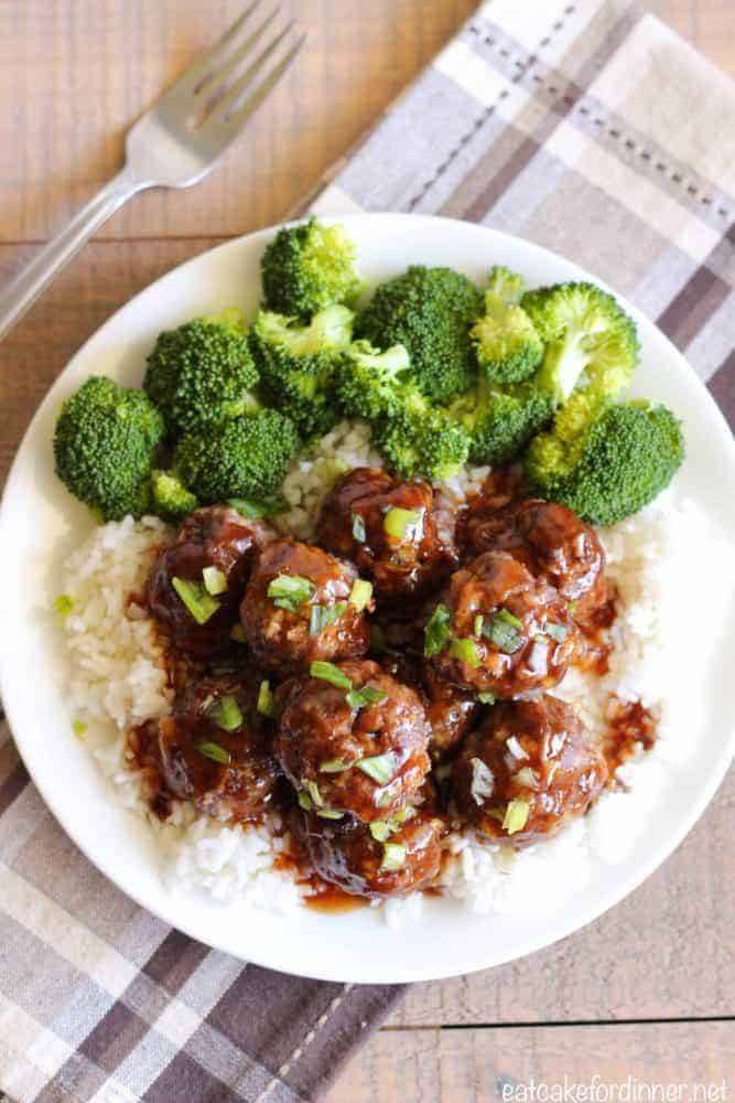 Easy Teriyaki Meatballs come together fast and make such an amazing meal with the delicious teriyaki sauce. They have a sweet and savory flavor from the teriyaki sauce coating a moist and tender meatball. Easy Teriyaki Meatballs with white rice, broccoli on a white plate.