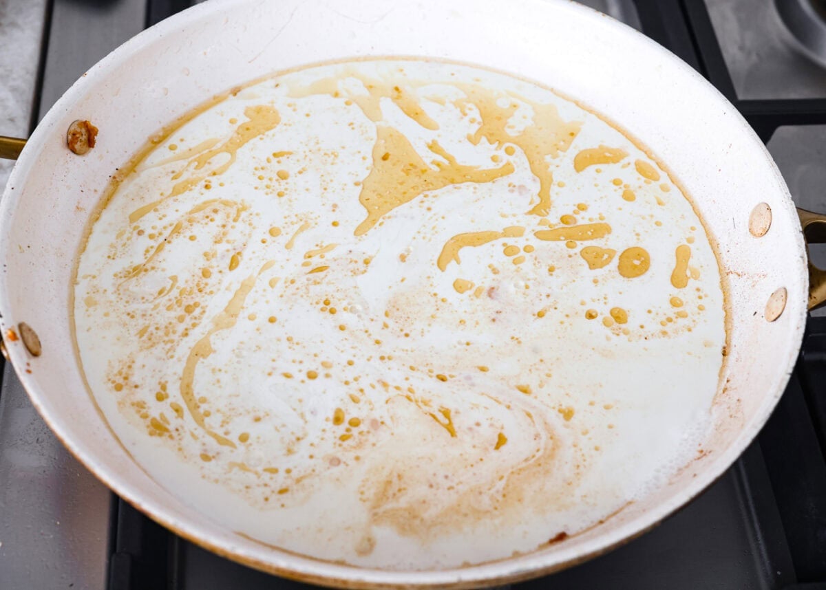 My Pan Seared Salmon has a new and improved Sauce! I added salt to bring out the flavors, and now it’s perfect! Fresh lemon juice and dill make it a match made in salmon heaven! Cream, broth, garlic and salt in a pan.