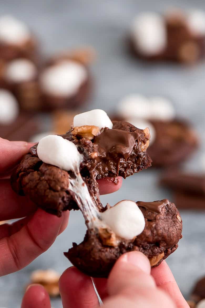 These rich Rocky Road Chocolate Cookies loaded with chocolate chunks, marshmallows, and walnuts are a chocolate lover’s dream come true! These rich Rocky Road Chocolate Cookies being pulled apart to show gooey insides.