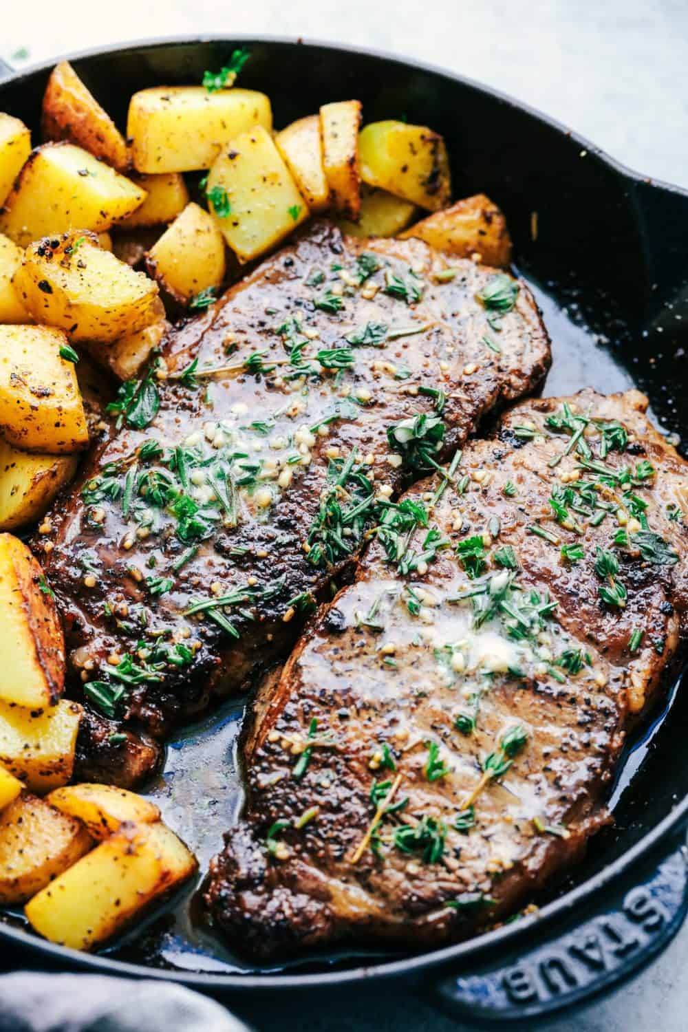 Skillet Garlic Butter Herb Steak and Potatoes is pan seared and cooked to perfection and topped with a garlic herb butter compound. This is the best steak that I have ever had!! Skillet Garlic Butter Herb Steak and Potatoes in a skillet.