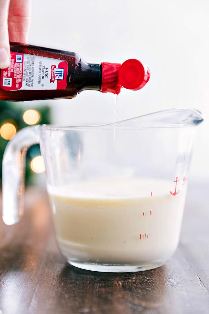 Glazed Eggnog Pound Cake is an easy to make tender and soft pound cake. It gets drizzled with a luscious glaze and is perfect for the holidays! Pouring Rum flavor into measuring cup.