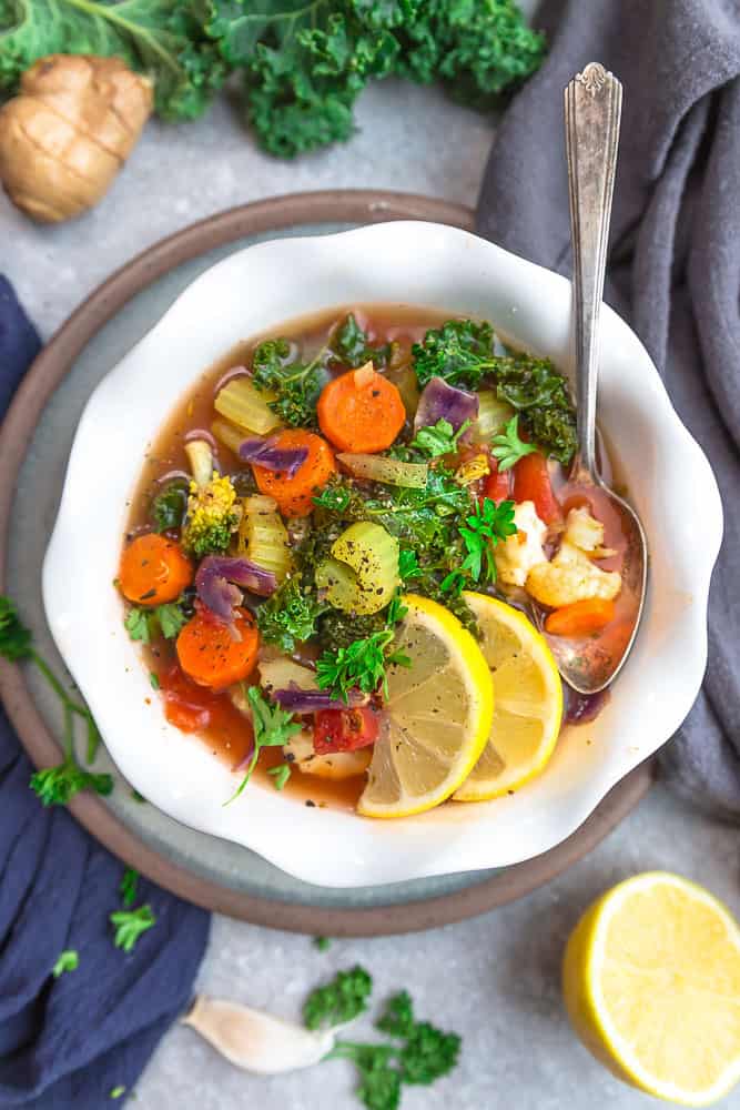 Vegetable Detox Soupย is an easy one pot recipe perfect for getting back on track for the new year! Best of all, it's comforting, flavorful and packed with lots of healthy vegetables. Vegetable detox soup served in a bowl with a spoon.